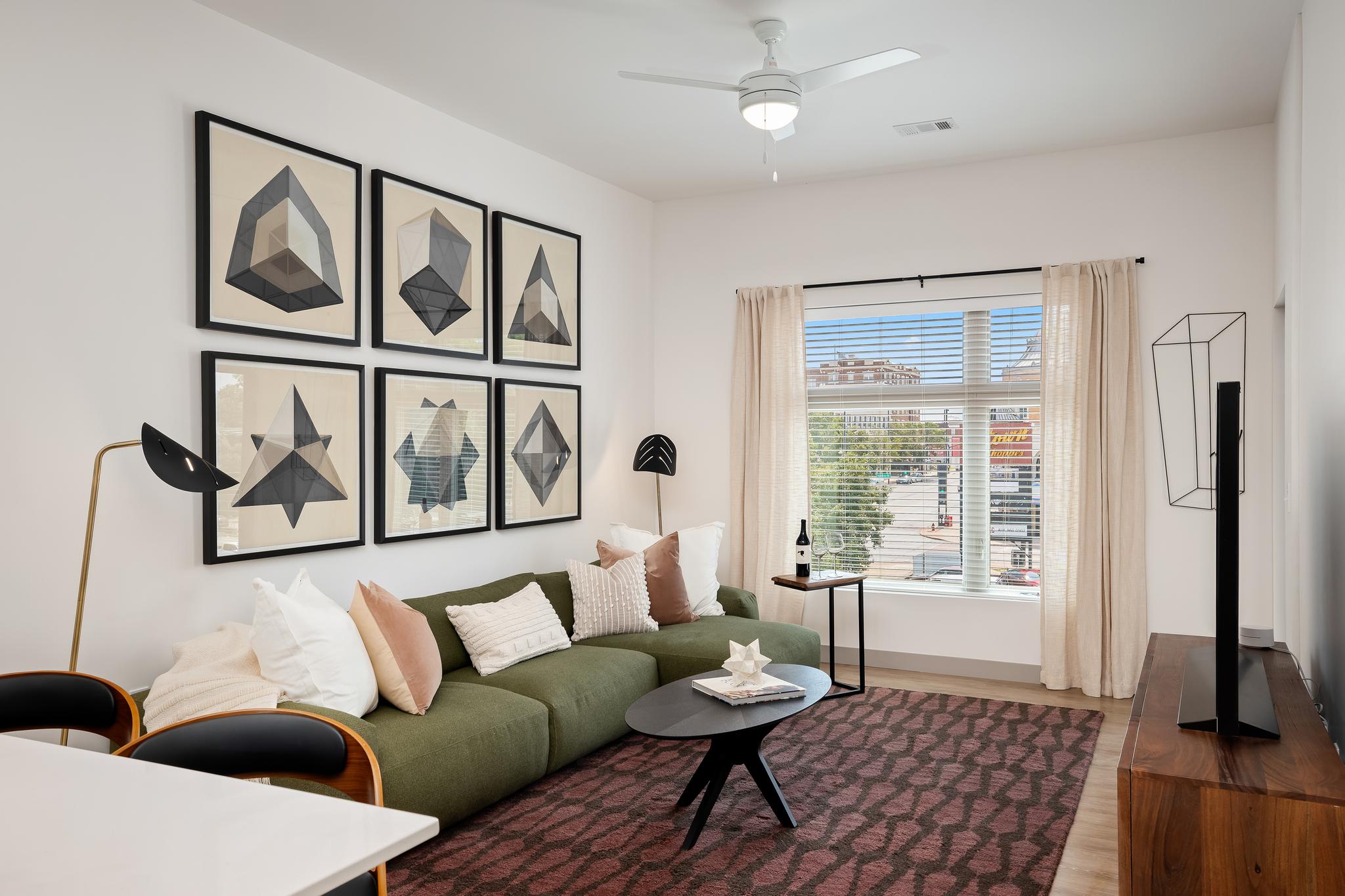 living room with oversized windows in luxury apartment overlooking uptown kansas city